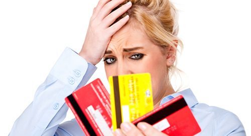Stressed out woman with 3 credit cards