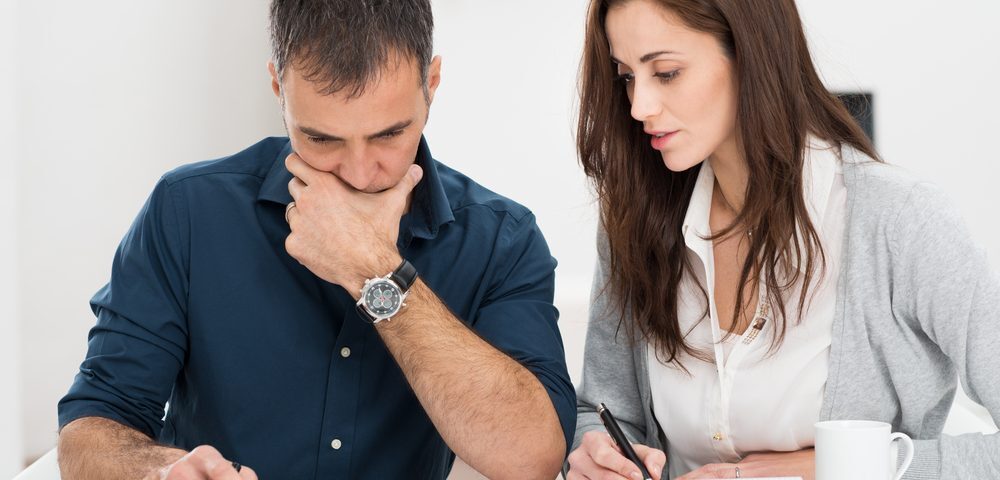 Man and a woman doing calculations