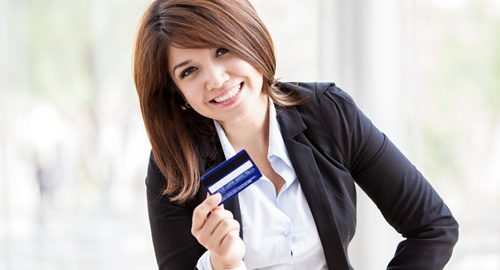 Happy and successful woman with a credit card
