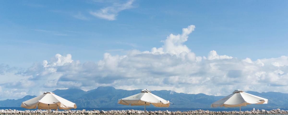 Lounge chairs and umbrellas in the sand at the beach