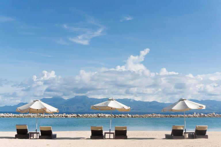 Lounge chairs and umbrellas in the sand at the beach