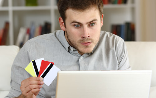 Upset man with 4 credit cards