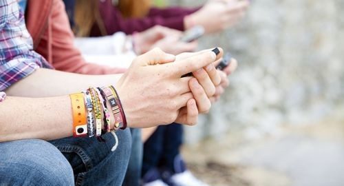 Students sitting down on mobile phones