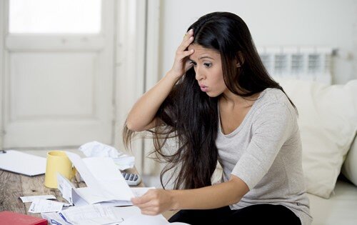 Stressed out woman with a lot of bills