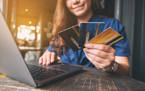 Woman holding 3 credit cards